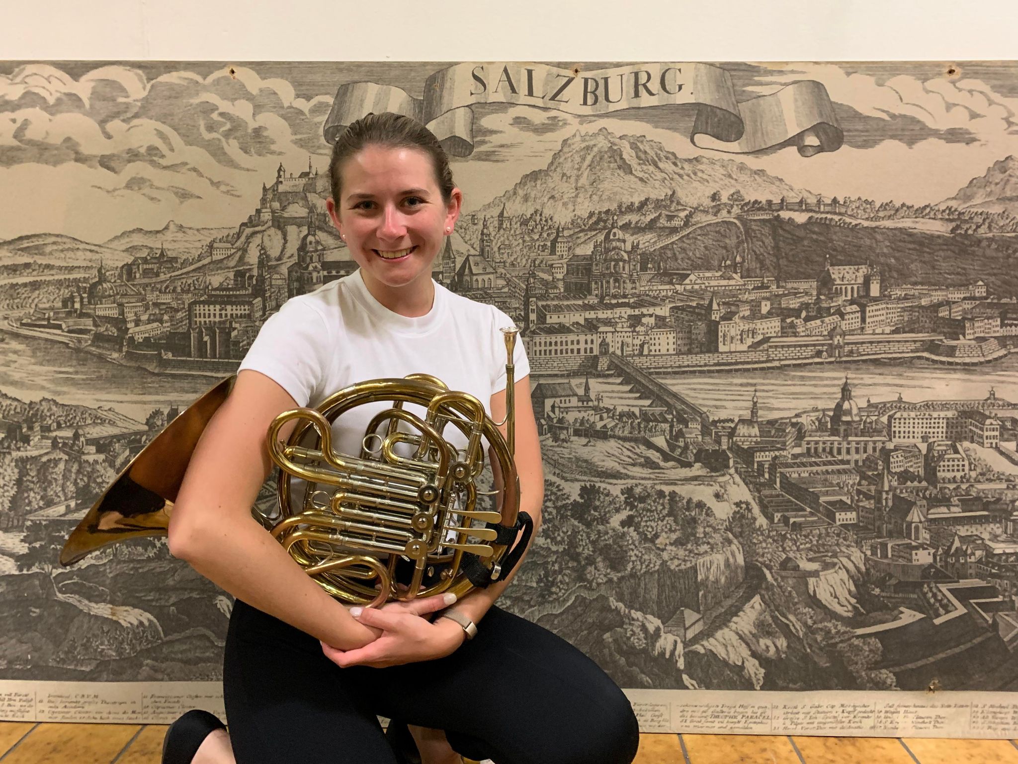 A young woman holding a trumpet.